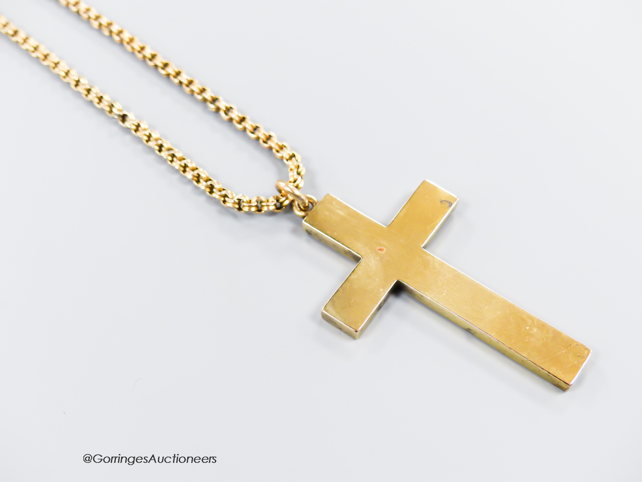 A hollow yellow metal cross pendant, 53mm, together with an Edwardian yellow metal choker chain, stamped 9c, 34cm